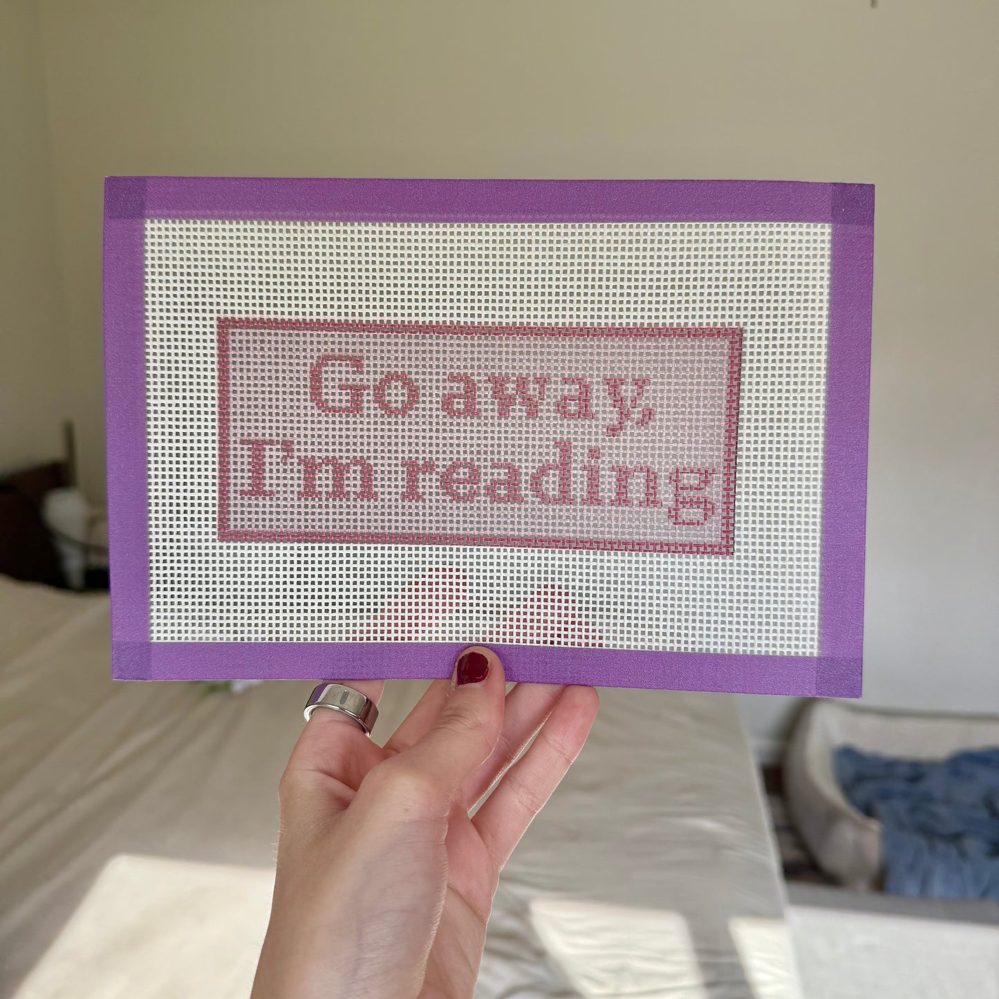Go away, I'm reading! pink needlepoint canvas